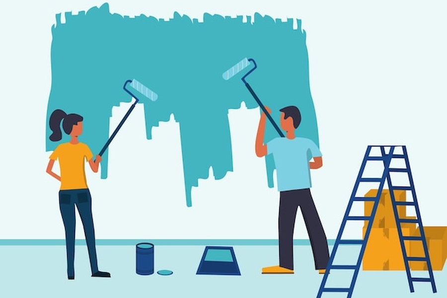 Deux personnes s'activant sur un projet de painting wall avec de la peinture turquoise et des rouleaux.