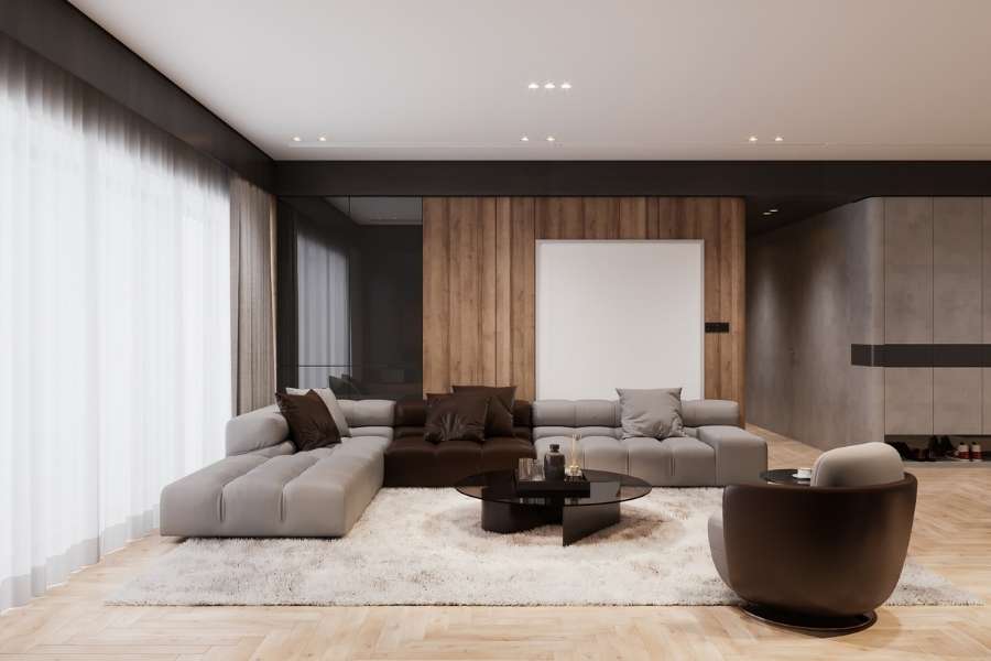Un salon contemporain illustrant un style de mobilier moderne et épuré avec un grand canapé d'angle.
